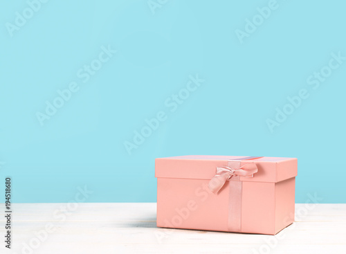 Pink gift box on blue background