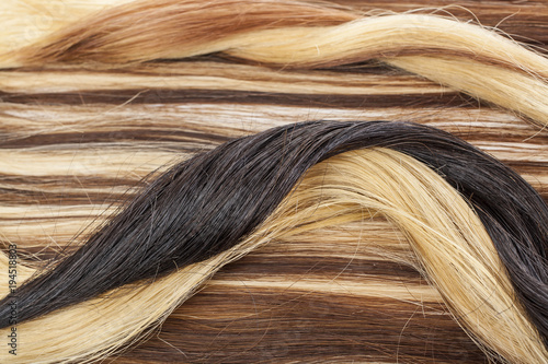 Real hair closeup. Hair texture pattern macro photo. Human european women's hair extension.