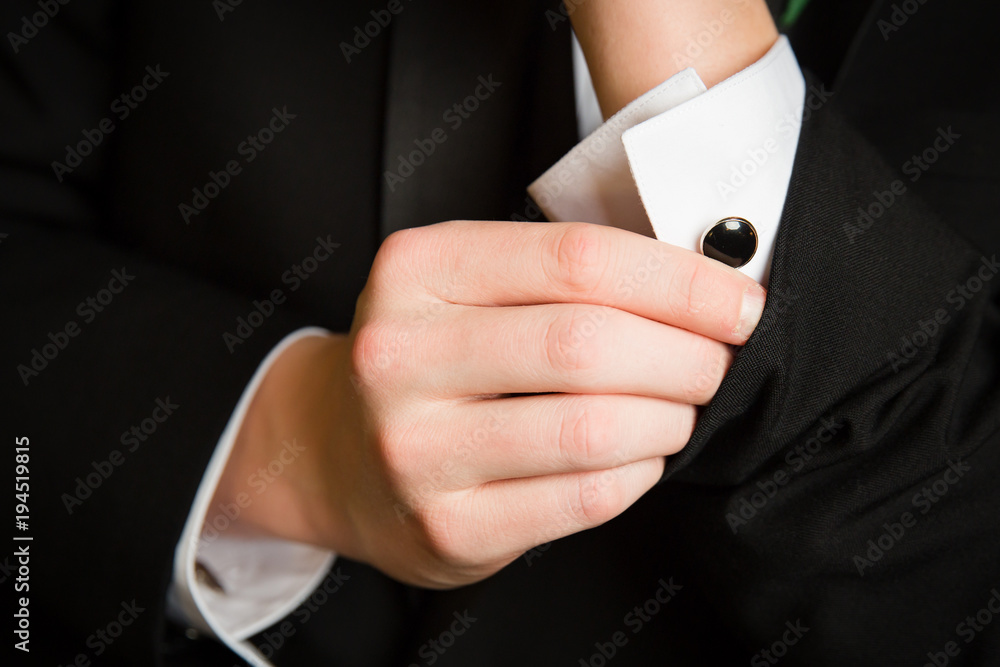 Fototapeta premium Teenager Adjusts Cufflinks for Prom