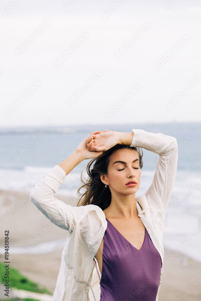 Beautiful Caucasian Woman Posing With Closed Eyes on Windy Beach Beautiful Caucasian Woman Posing With Closed Eyes on Windy Beach