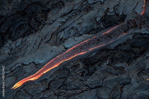 Aerial photo of lava flow, diagonally crossing the image like a finger pointing down