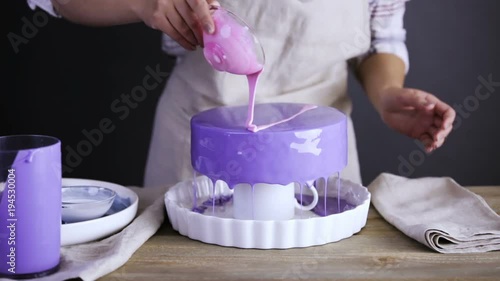 Step by step. Pastre shef glazing mousse cake with purple mirror glaze photo