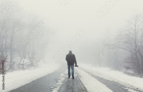 Nature photographer on foggy road