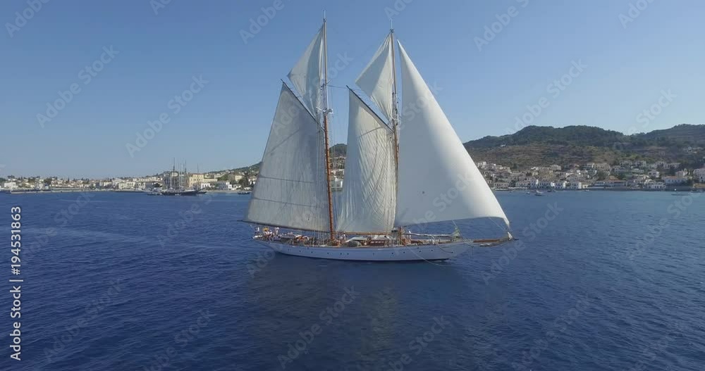 Cinematic drone shot of luxury yacht sailing near the island of Spetses Cinematic drone shot of luxury yacht sailing near the island of Spetses