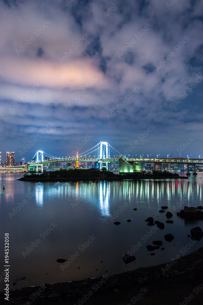 Tokyo skyline at night view from Odaiba with Rainbow bridge, Liberty statue and Tokyo tower in the background