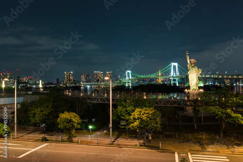 Tokyo skyline at night view from Odaiba with Rainbow bridge, Liberty statue and Tokyo tower in the background