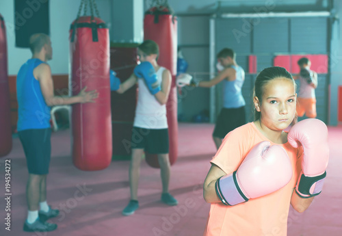 Portrait of ordinary girl boxer in boxing hall © JackF