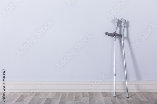 Fotobehang Two Crutches In Room
