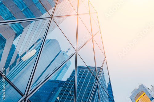 Reflections of modern commercial buildings on glasses with sun light