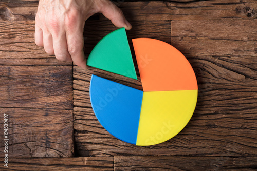 Fotografija Businessperson Placing A Last Piece Into Pie Chart