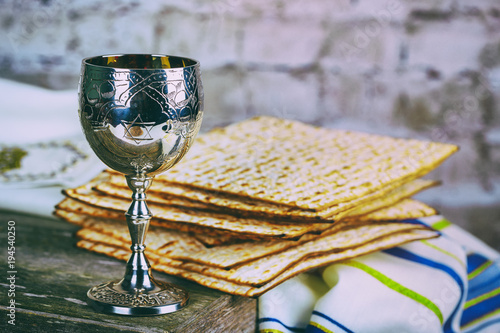 Silver wine cup with matzah, Jewish symbols for the Passover Pesach holiday. Passover concept.