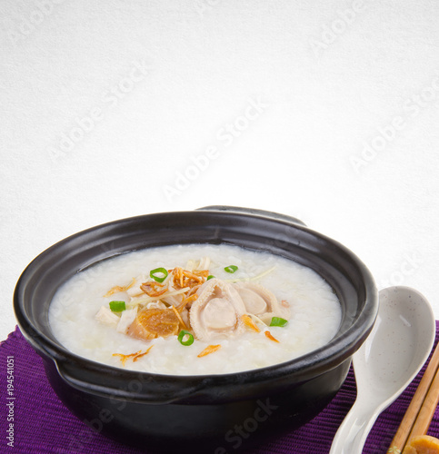 Porridge or abalone porridge in claypot on a background.