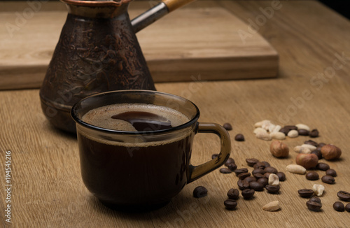 brown mug with coffee and coffee turka, on a wooden table