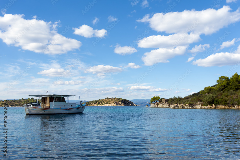 A fishng boat on the gorgeous sea waters of Sithonia, Chalkidiki, Greece A fishng boat on the gorgeous sea waters of Sithonia, Chalkidiki, Greece