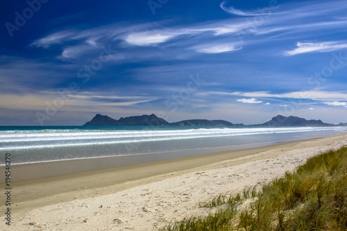 Fototapeta Naklejka Na Ścianę i Meble -  White Sand Beach With Blue Sky at Waipu in New Zealand