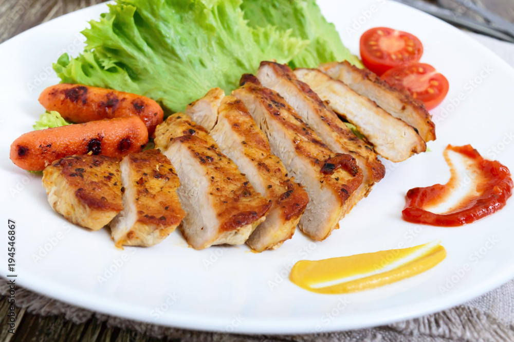 Juicy grilled meat , vegetable, lettuce leaves and sauces. Healthy food.