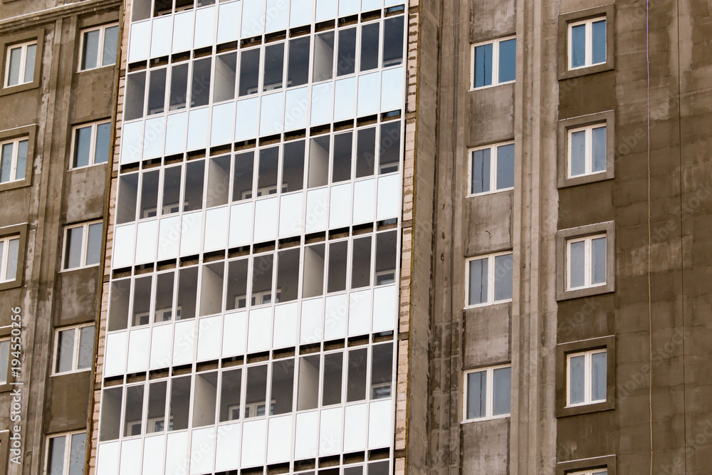 Windows in a multi-storey building under construction as a background Windows in a multi-storey building under construction as a background