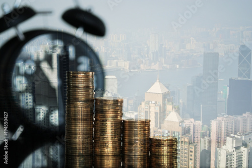 Double exposure Step of coins and tablet computer with financial graph and city background, business planning vision and finance analysis concept. © pookpiik