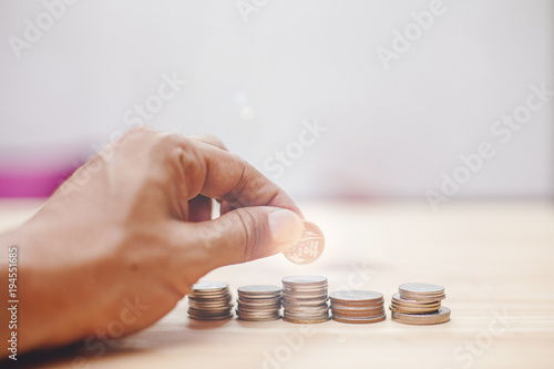 Coin and hand money saving concept, Coin put to stack by man hand for business finnace concept