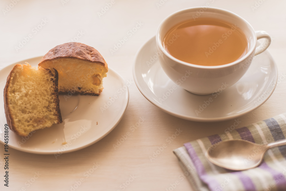 cup of green tea, fresh cake and a napkin on a light table - rustic breakfast cup of green tea, fresh cake and a napkin on a light table - rustic breakfast