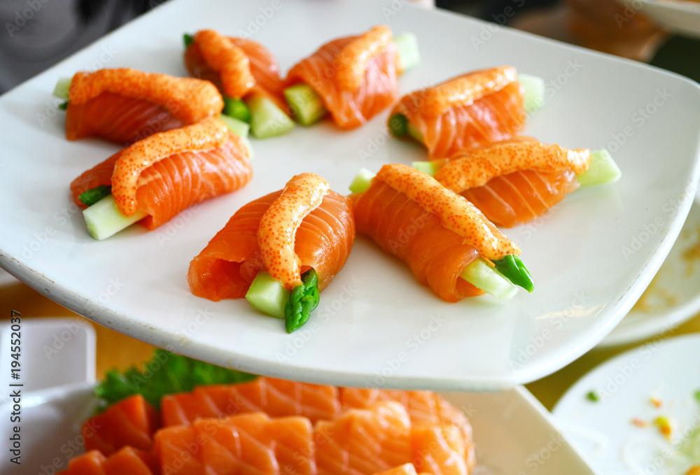 Salmon role sushi on the white dish Salmon role sushi on the white dish
