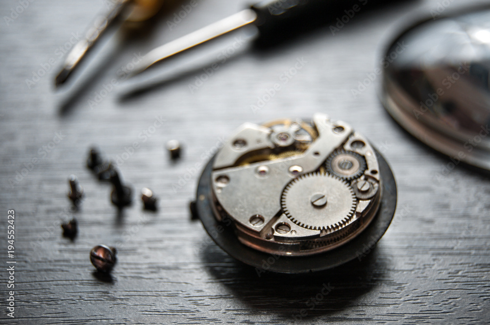 old watch repair composition with magnifier and screwdrivers