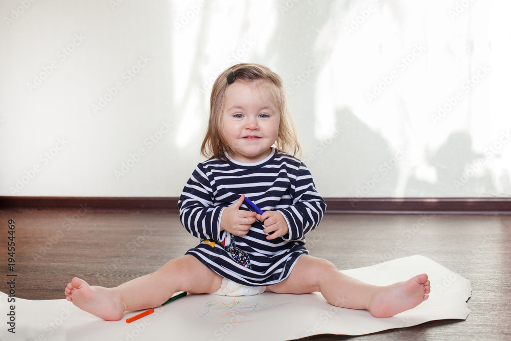 the girl sits on the floor in the room and laughs, grimaces the girl sits on the floor in the room and laughs, grimaces