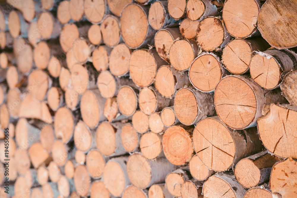 Pile firewood prepared for fireplace. Wooden background - closeup. Pile firewood prepared for fireplace. Wooden background - closeup.