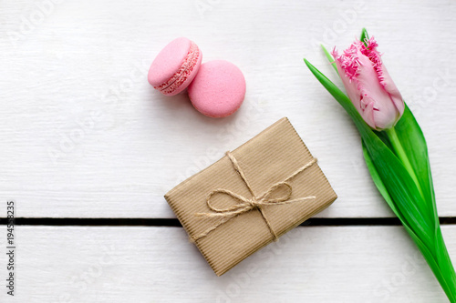 Tulip, gift boxes and macaroons wooden white background