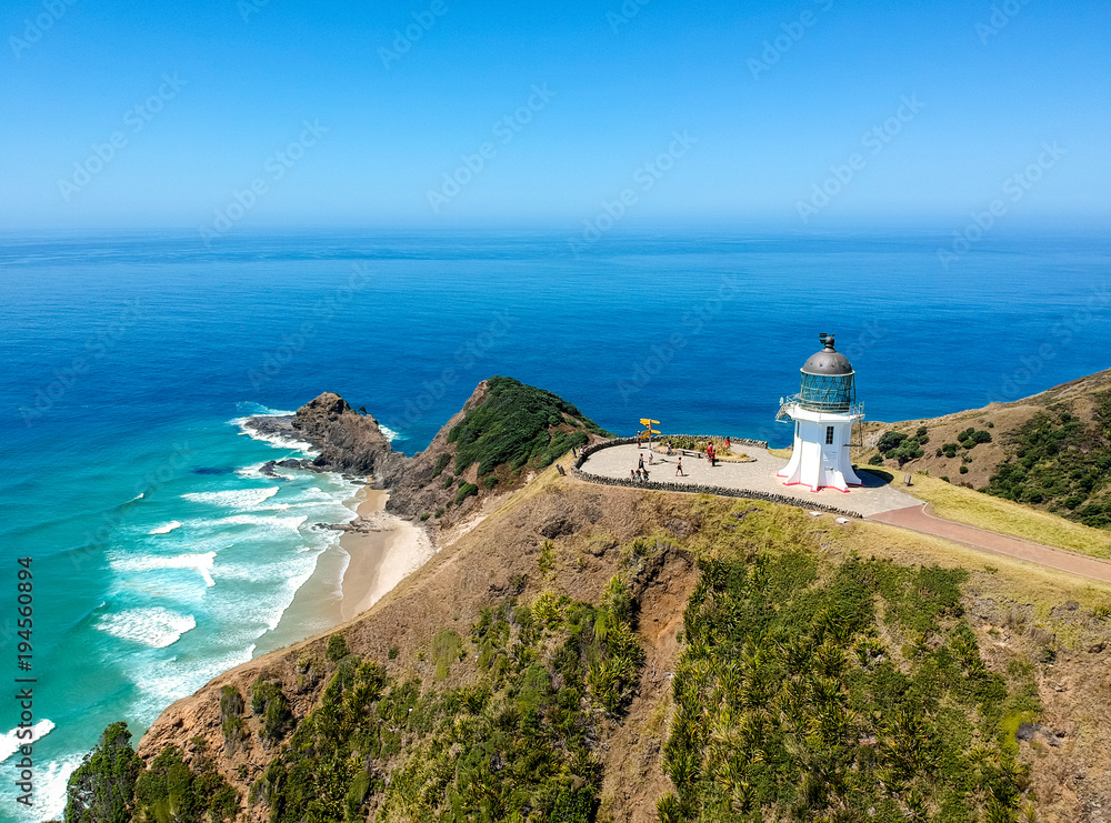 Stunning wide angle aerial drone view of Cape Reinga Lighthouse at Cape Reinga, the northernmost point of the North Island of New Zealand. The lighthouse is a famous tourist attraction.