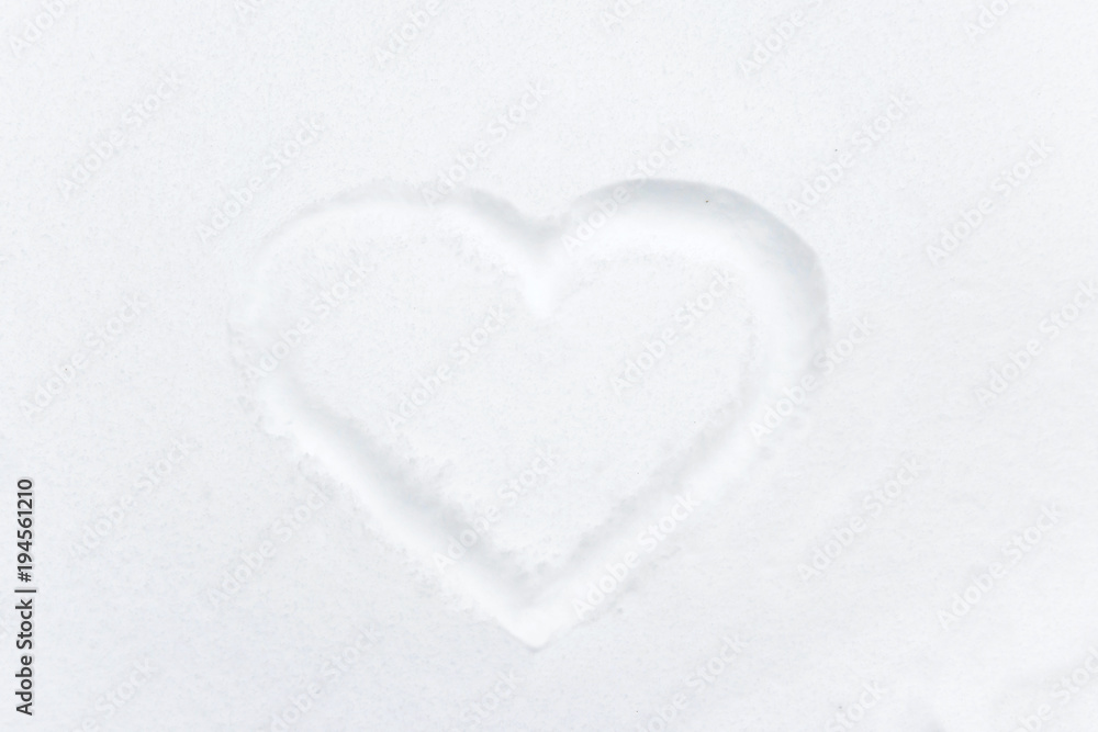 Heart shape drawing on white snow Heart shape drawing on white snow