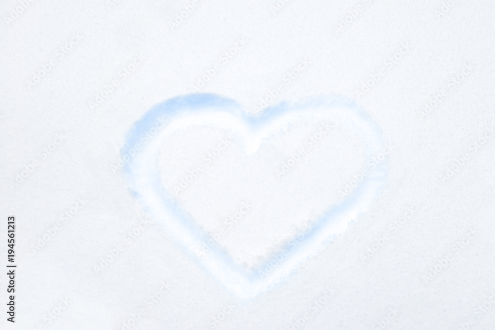 Blue heart shape drawing on white snow