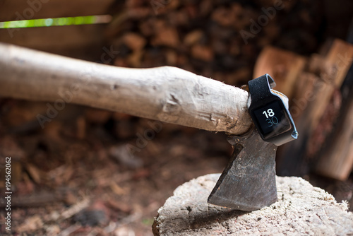 Smartwatch on the ax. The ax in the stump. Close-up. Firewood. Chopping wood.