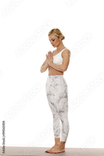 Yoga, sport, training and lifestyle concept. Portrait of young beautiful woman in white sportswear on white background.