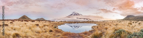 Reflection in Pouakai Tarn, stratovolcano Mount Taranaki or Mount Egmont at sunset, Egmont National Park, Taranaki, North Island, New Zealand, Oceania