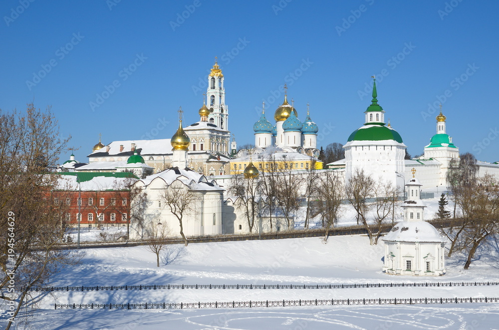 View from Blinnaya hill of snow-covered architectural ensemble of Holy Trinity - St. Sergius Lavra with Chapel of Pyatnitsky Well in front of the monanastery, Moscow region, Russia