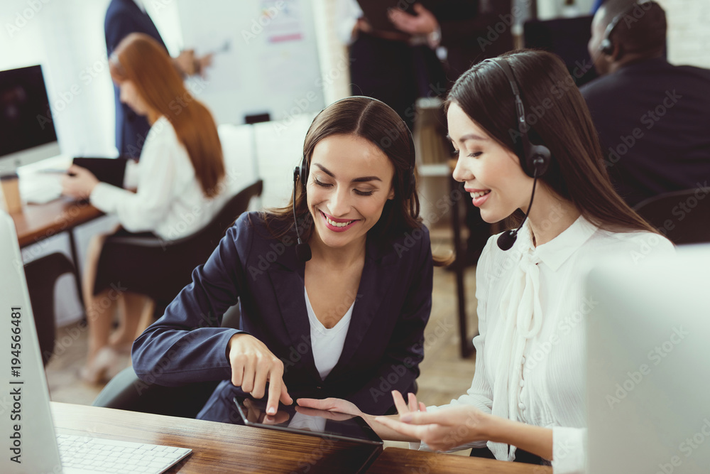 Girls-operators of the call center communicate with each other. Girls-operators of the call center communicate with each other.