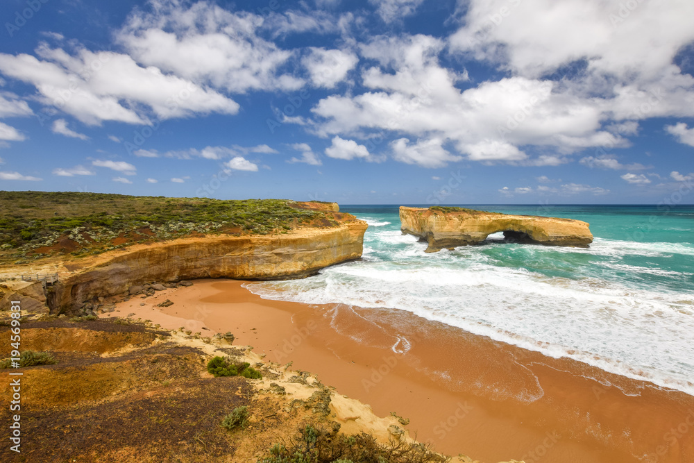 Beautiful view of the a rock arch called the London Bridge located along the Great Ocean Road near the Twelve Apostles in Victoria, Australia. The Great Ocean Road is a famous tourist destination.