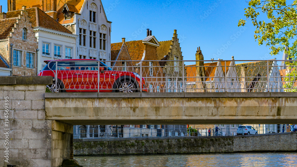 Naklejka premium Belgium, Brugge a car passing on a bridge in the old bruges