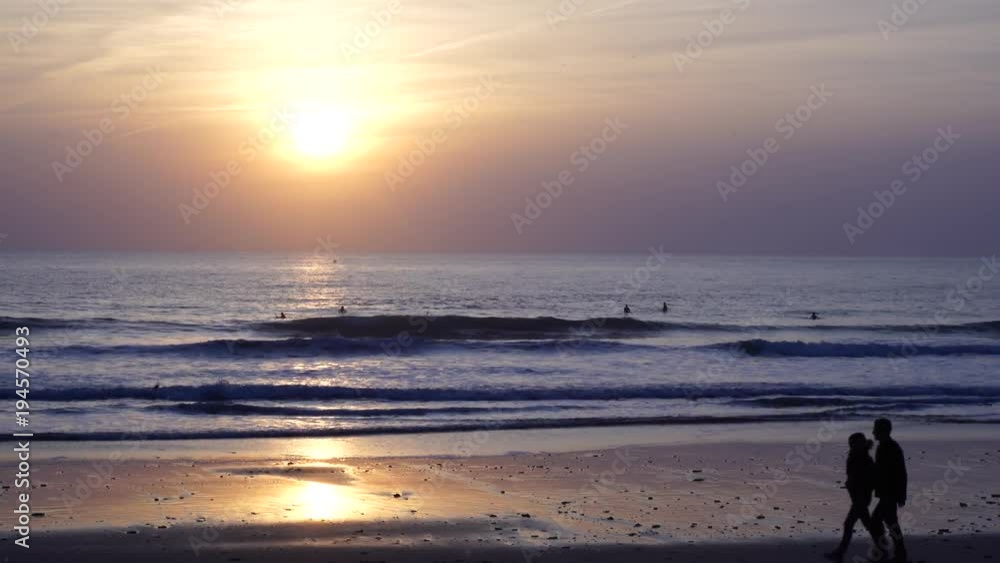 Landscape of perfect sunset with beautiful clouds and silhouette of people walking Landscape of perfect sunset with beautiful clouds and silhouette of people walking