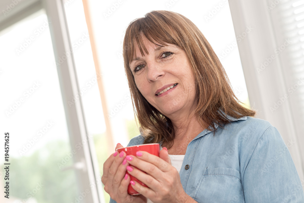 Mature woman during coffee break at home Mature woman during coffee break at home