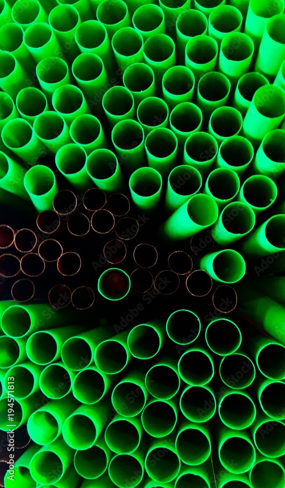 Top view of many light green and dark brown circle tubes Top view of many light green and dark brown circle tubes