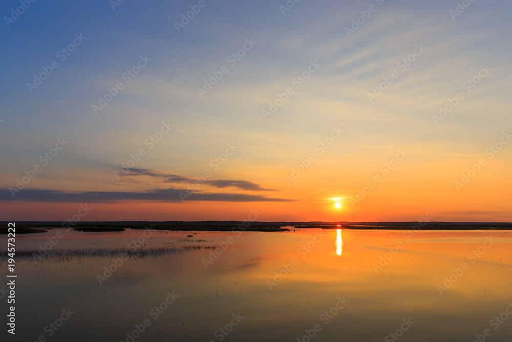 Panorama of beautiful sunset on lake.