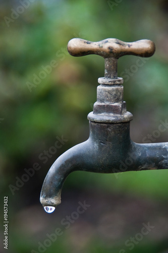 copper tap with water drop on blurred background