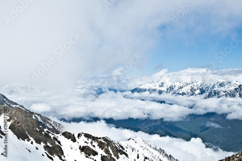 landscapes of the slopes of the mountains in the snow, something which is a forest
