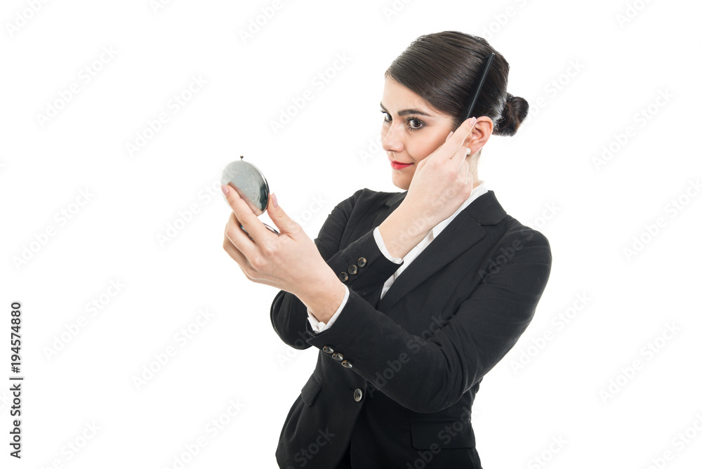 Beautiful female flight attendant using comb looking in mirror Beautiful female flight attendant using comb looking in mirror