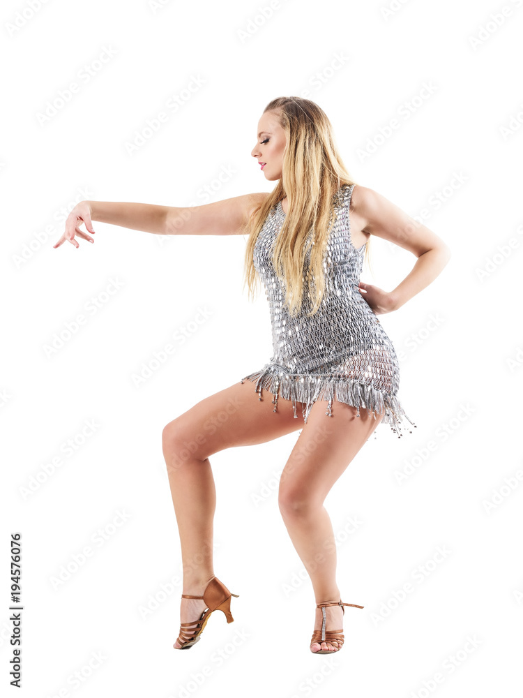 Dance choreography posture of blonde woman in shiny metallic silver dress. Side view. Full body length portrait isolated on white studio background. Dance choreography posture of blonde woman in shiny metallic silver dress. Side view. Full body length portrait isolated on white studio background.