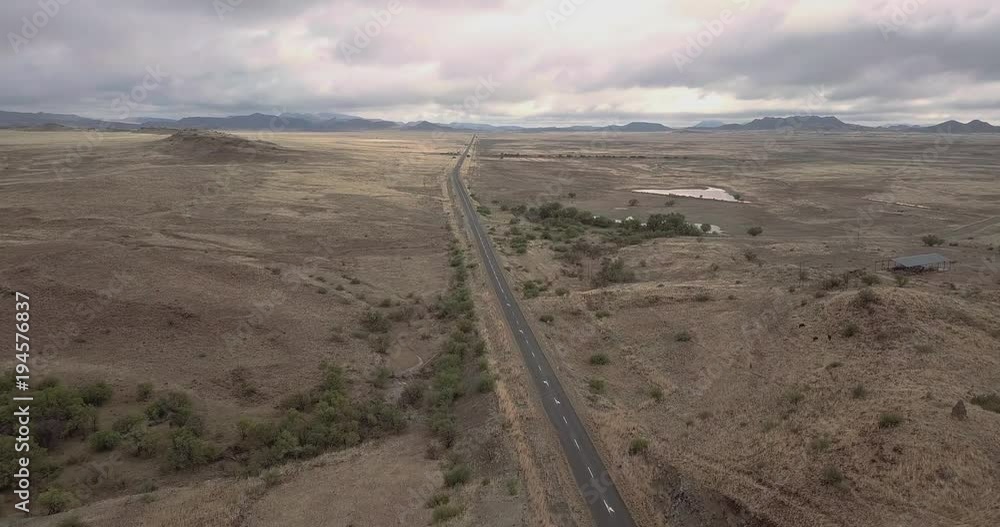 Aerial shot of mountain road with moody cloudy sky. Aerial shot of mountain road with moody cloudy sky.