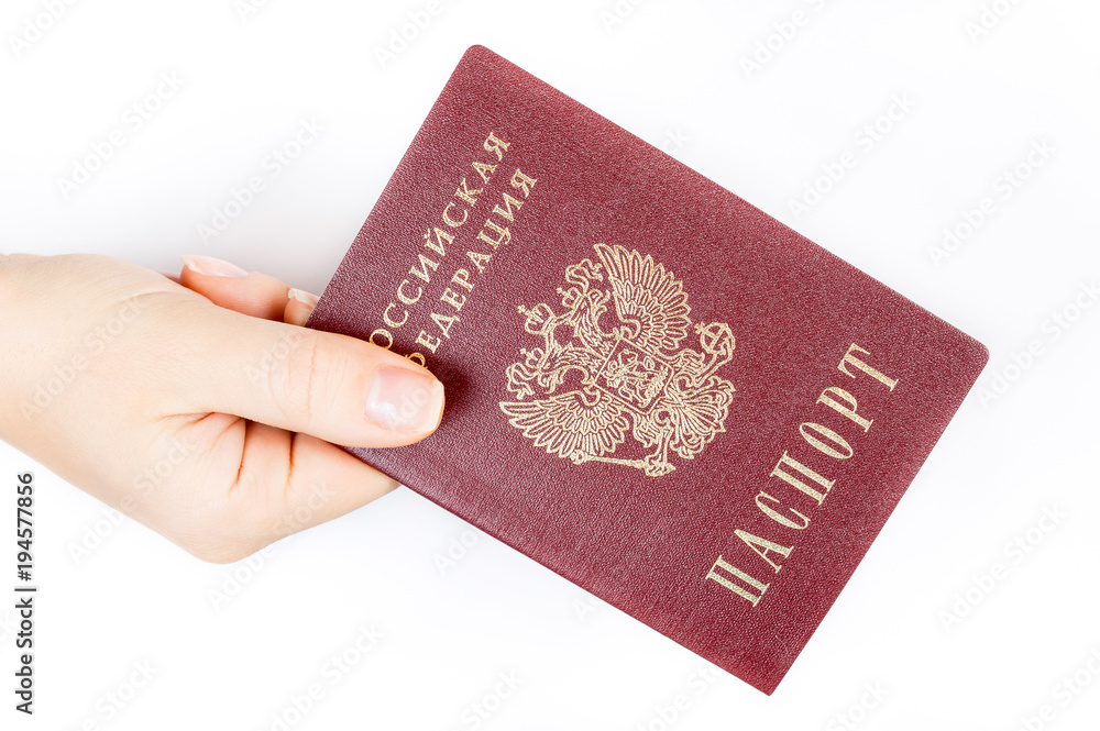 Hand gives a Russian passport on white background Hand gives a Russian passport on white background