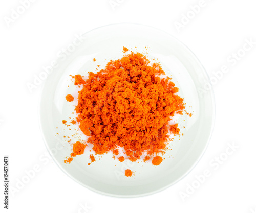 Turmeric powder in white plate on white background